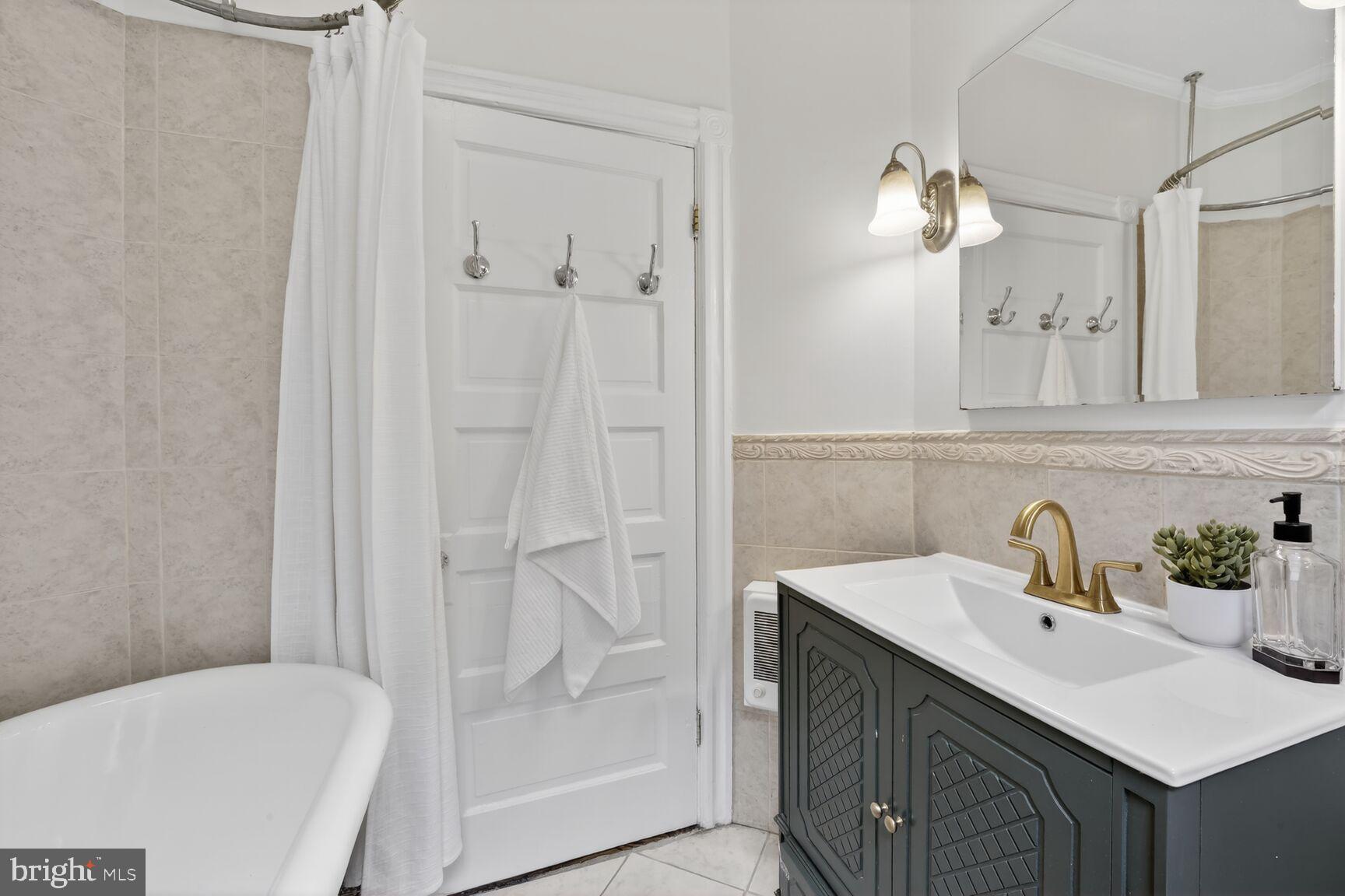 1612 V Street Northwest Washington, DC 20009 - Photo 14 of 29 a bathroom with a sink a toilet and shower