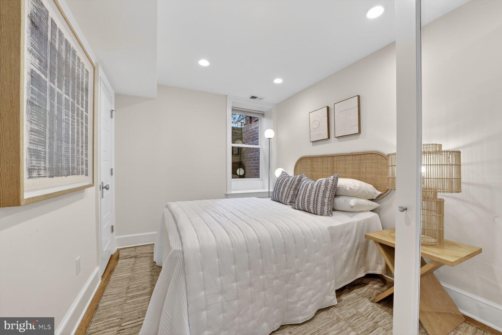 1612 V Street Northwest Washington, DC 20009 - Photo 23 of 29 a bedroom with a bed and a painting on the wall