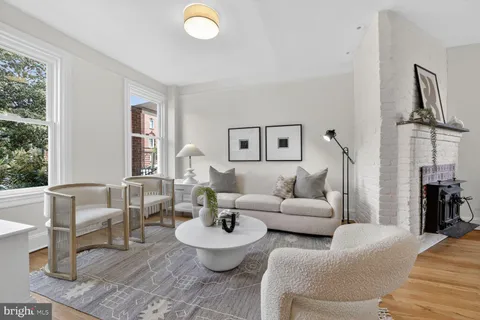 a living room with furniture a rug and a large window