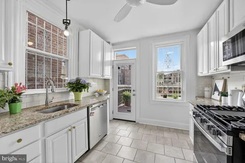 a kitchen with a sink stove and cabinets