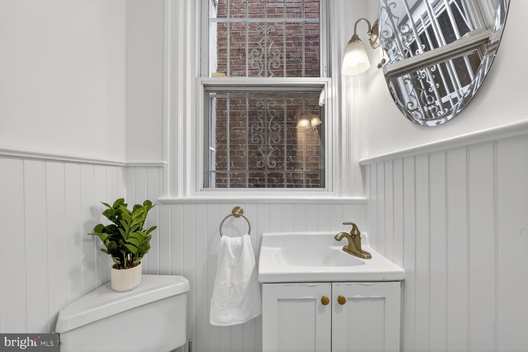 1612 V Street Northwest Washington, DC 20009 - Photo 8 of 29 a bathroom with a sink a toilet and a window