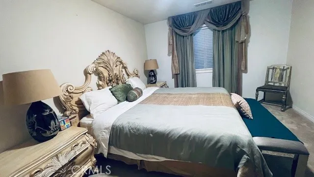 a bedroom with bed and window