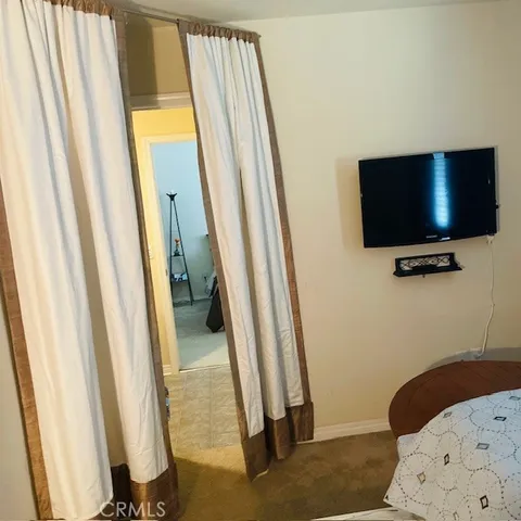 a bedroom with a bed and a piano in it