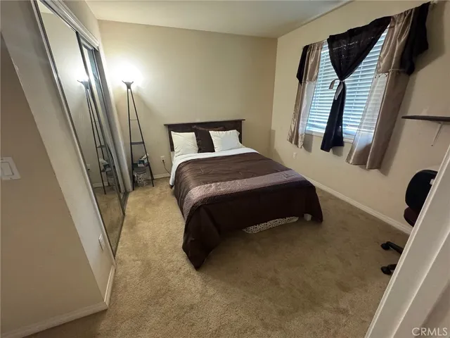 a bedroom with a bed and a mirror