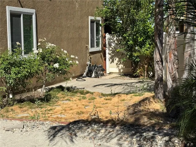 a pathway of a house with a yard