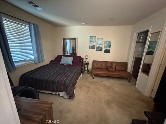 a bathroom with a sink and mirror with bathtub