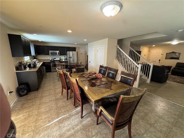 a living room with furniture a couch and a dresser with wooden floor