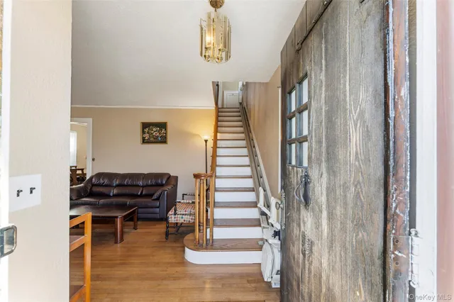 a view of entryway and hall with wooden floor