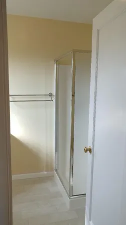 a bathroom with a glass shower door