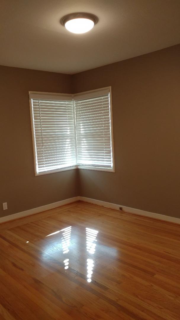 36871 Locust Street Newark, CA 94560 - Photo 10 of 14 an empty room with wooden floor and windows