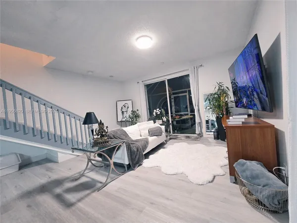 a bedroom with furniture and a large window