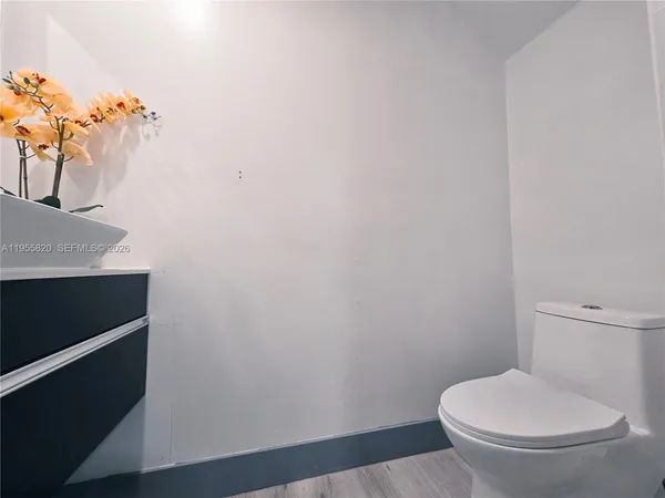 a white toilet sitting next to a shower