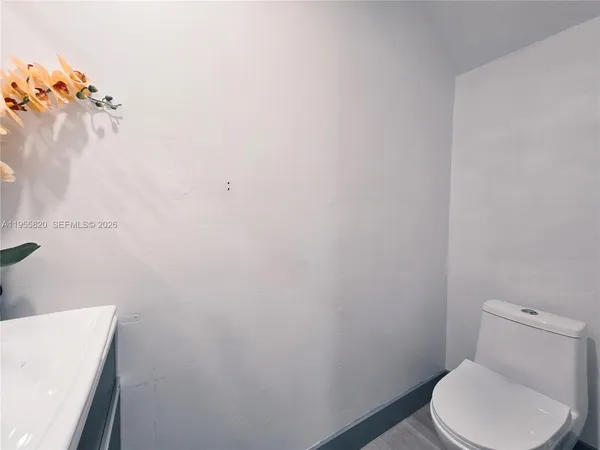 a white toilet sitting next to a white sink