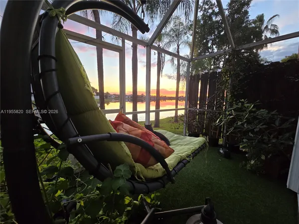 a roof deck with couch and garden view