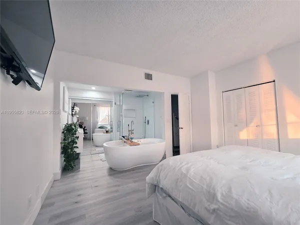 a spacious bedroom with a bed and a couch