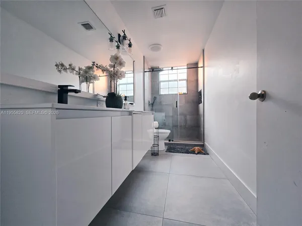 a kitchen with stainless steel appliances a refrigerator and cabinets