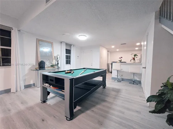a room with pool table and a couch