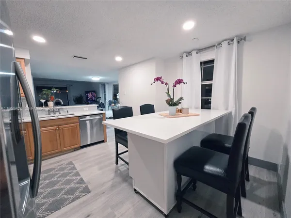 a view of kitchen with a dining table chairs and a oven