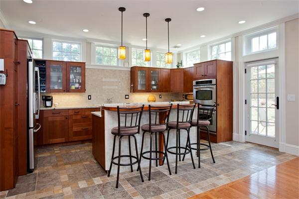 108 Albemarle Road Newton, MA 02460 - Photo 5 of 9 a kitchen with stainless steel appliances kitchen island granite countertop a refrigerator a stove a sink dishwasher with a dining table and chairs