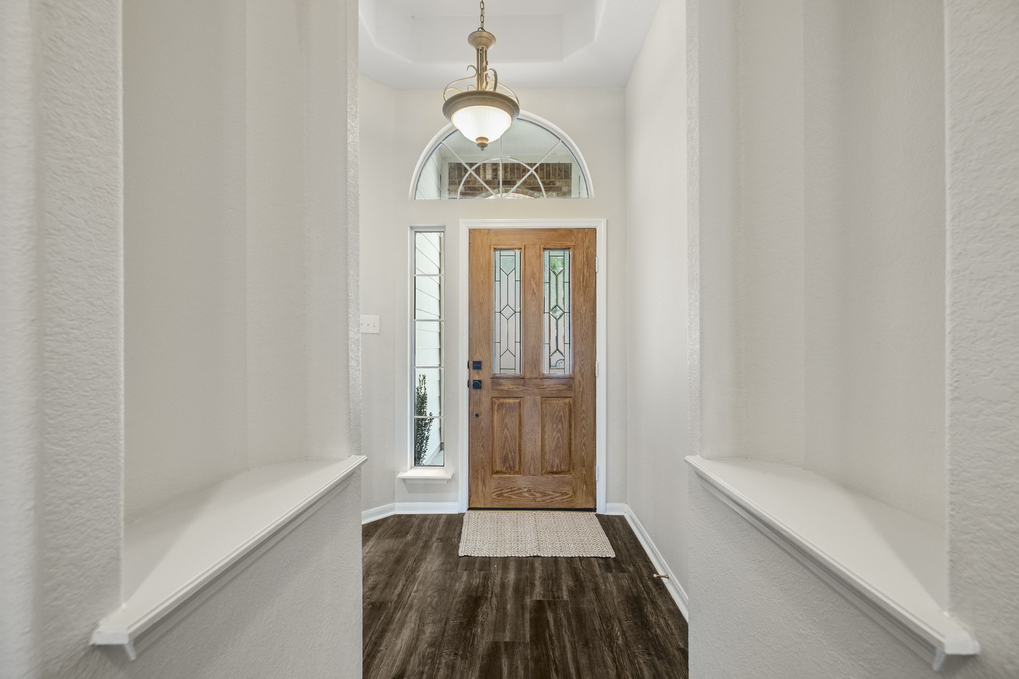 3422 Falcon Trail Court Spring, TX 77373 - Photo 4 of 35 a hallway with wooden floor window and a bathroom