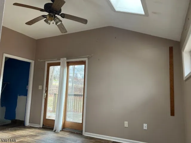 a view of a room with a ceiling fan and window