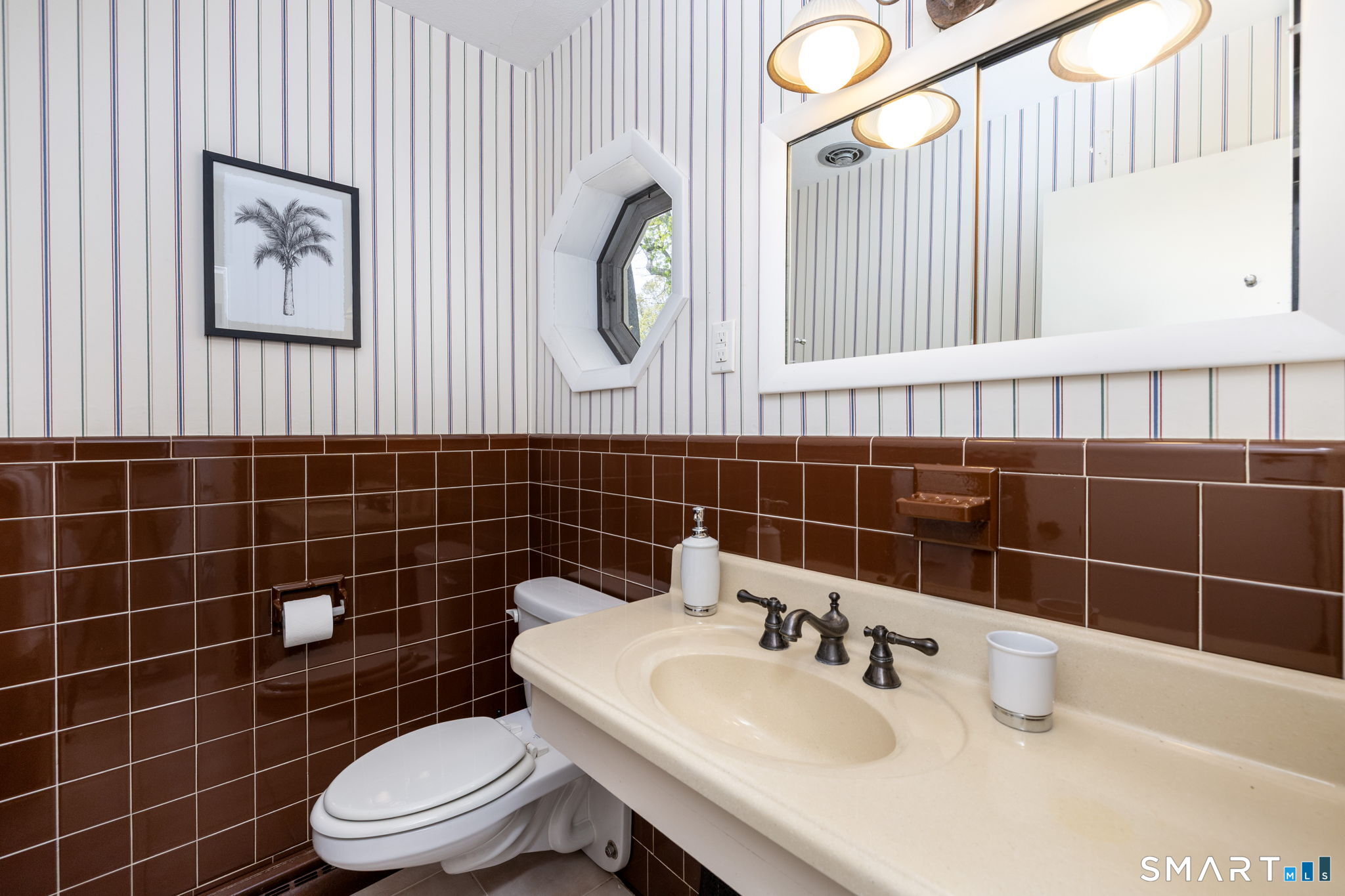 57 Jean Road Manchester, CT 06040 - Photo 18 of 38 a bathroom with a sink a toilet and a mirror