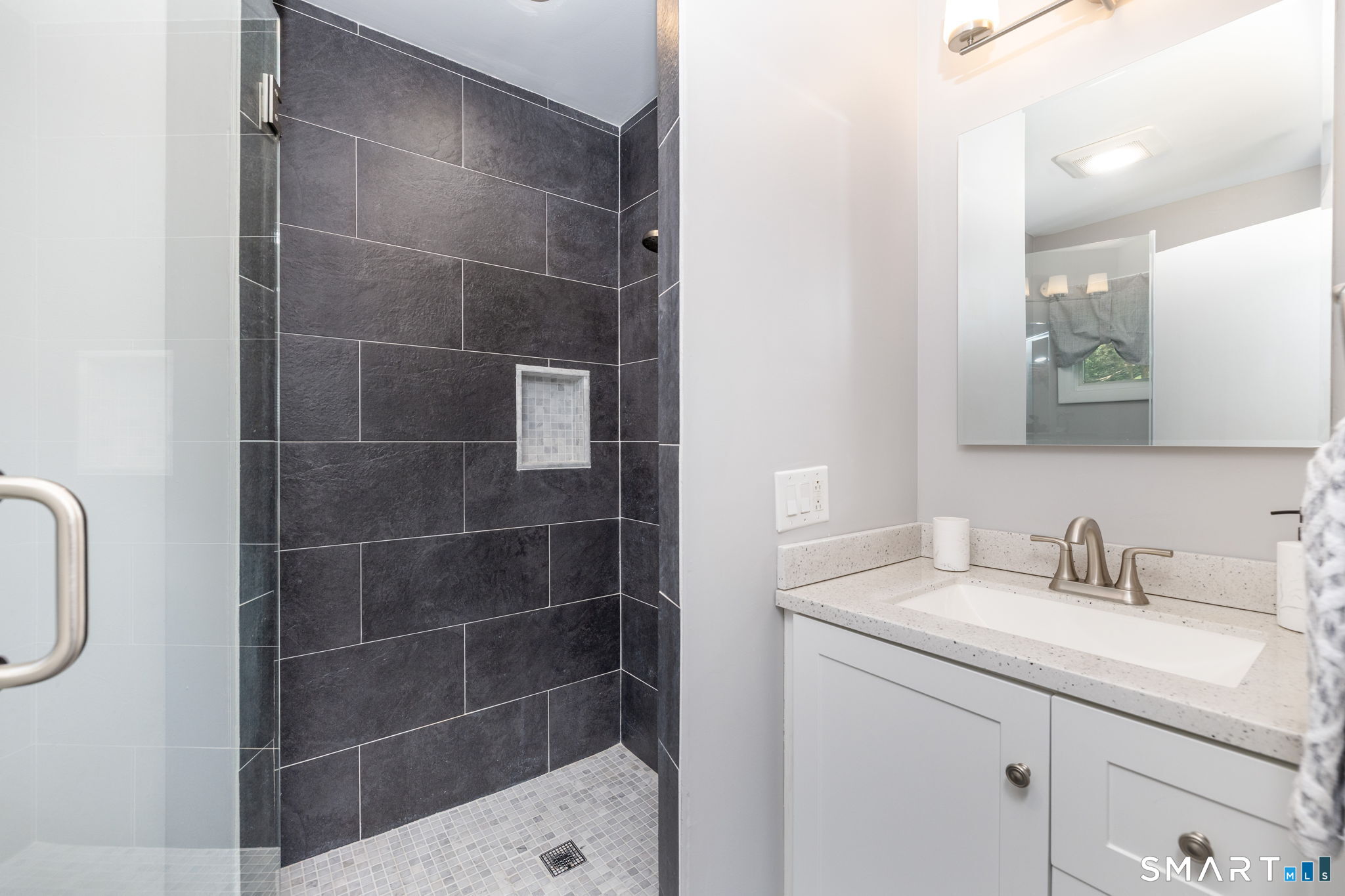 57 Jean Road Manchester, CT 06040 - Photo 26 of 38 a bathroom with a sink a toilet and a mirror