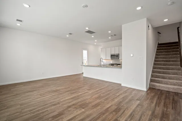 a view of kitchen with wooden floor and electronic appliances