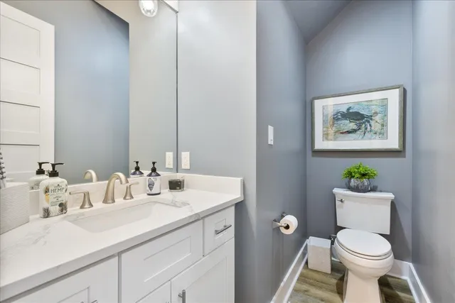 a bathroom with a toilet a sink and a mirror