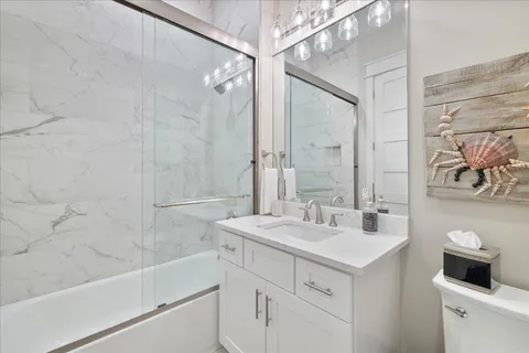 a bathroom with a double vanity sink mirror and shower