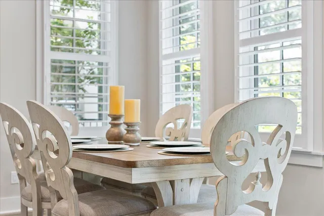 a dining room with furniture and wooden floor