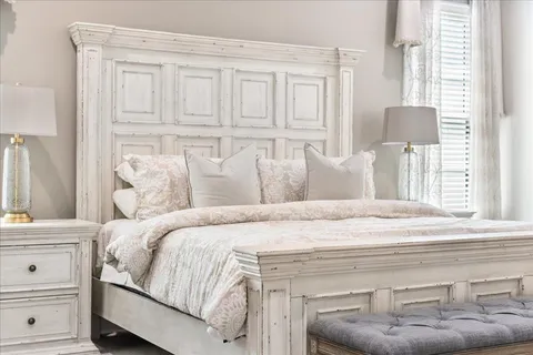 a bedroom with a bed and cabinet