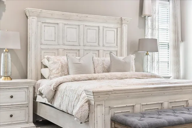 a bedroom with a bed and cabinet