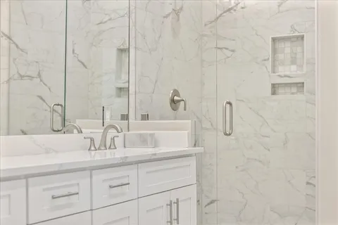 a bathroom with a granite countertop sink and a mirror