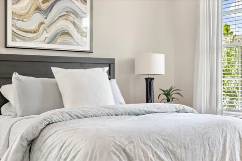 a bedroom with a bed and a window