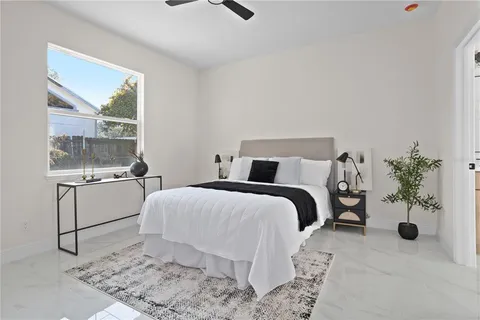 a bedroom with a bed and a potted plant