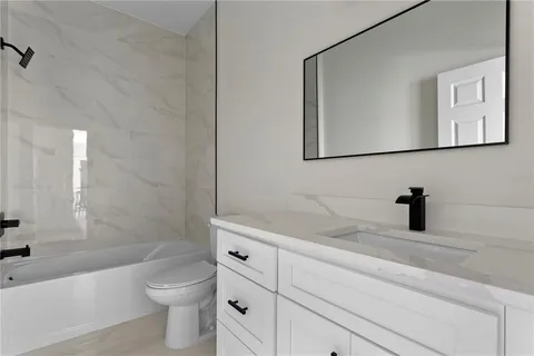 a bathroom with a toilet sink and bathtub