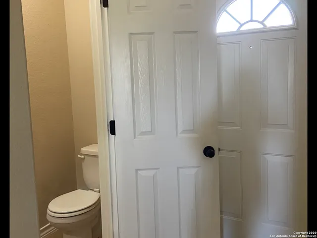 a white toilet sitting next to a shower curtain