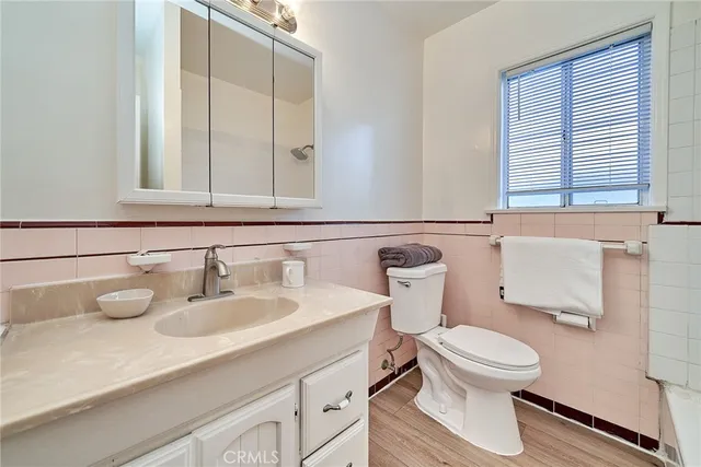 a bathroom with a sink a toilet and bathtub