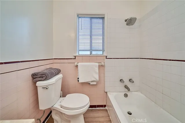 a bathroom with a double vanity sink a toilet and a mirror