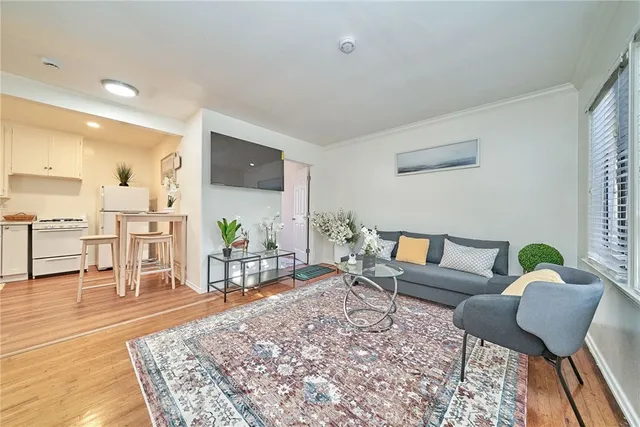 a kitchen with a refrigerator a stove top oven and white cabinets
