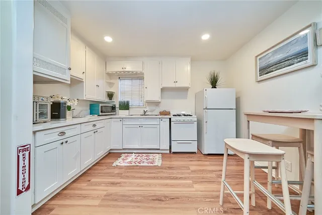 a kitchen with stainless steel appliances granite countertop a sink and cabinets