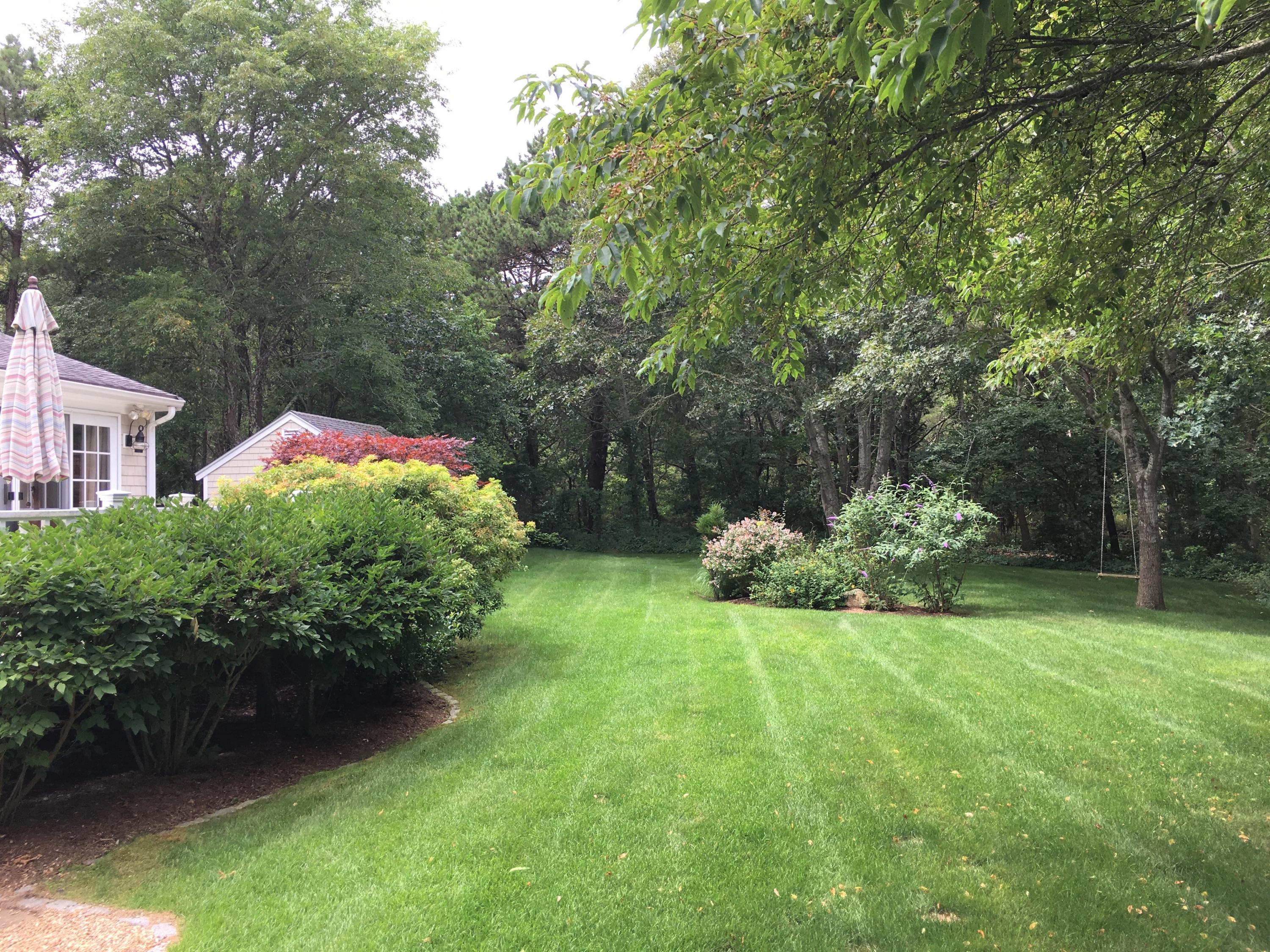112 3rd Street North Edgartown, MA 02539 - Photo 14 of 15 a view of a house with a yard and a garden