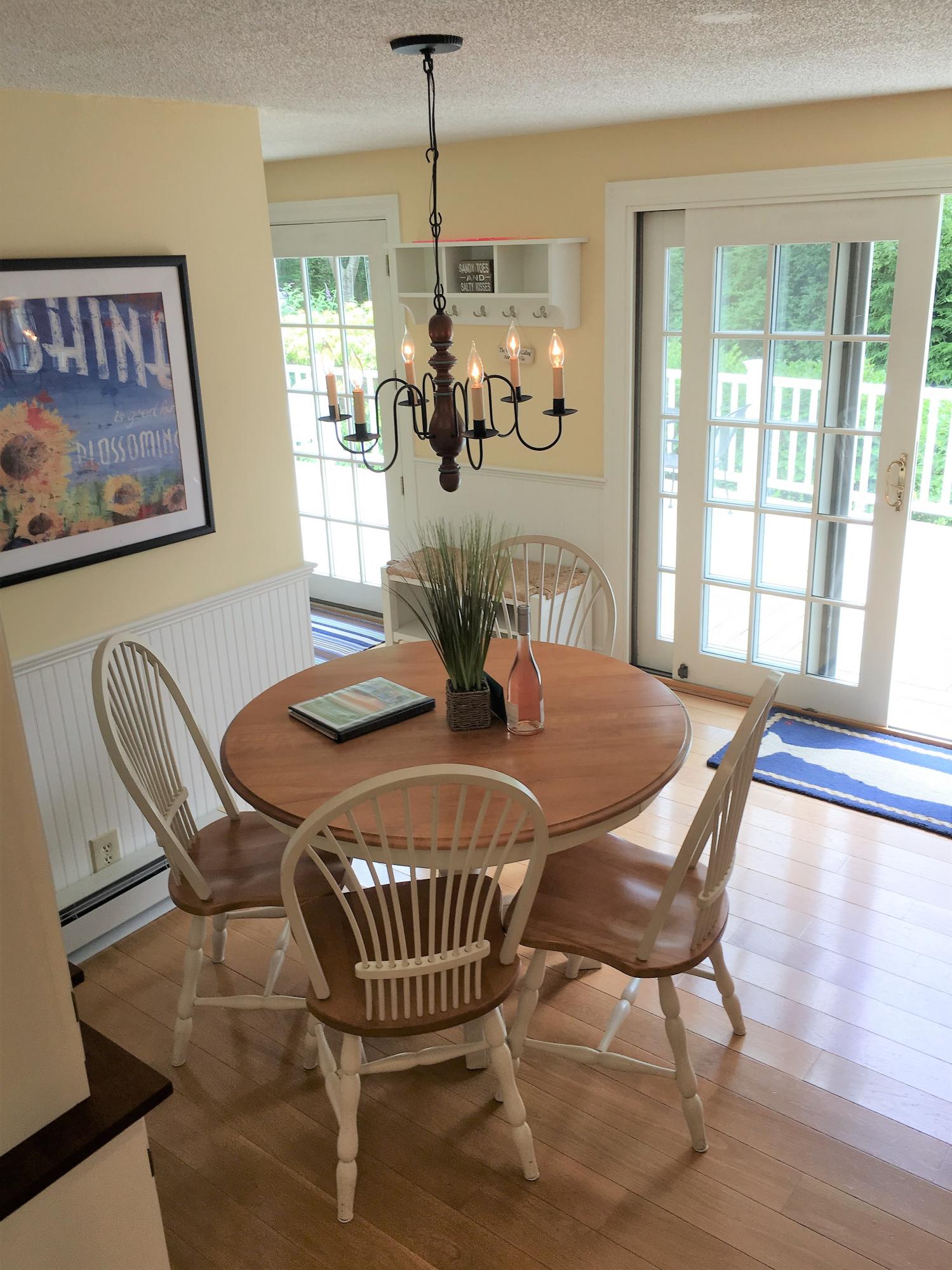 112 3rd Street North Edgartown, MA 02539 - Photo 6 of 15 a dining room with furniture a chandelier and wooden floor