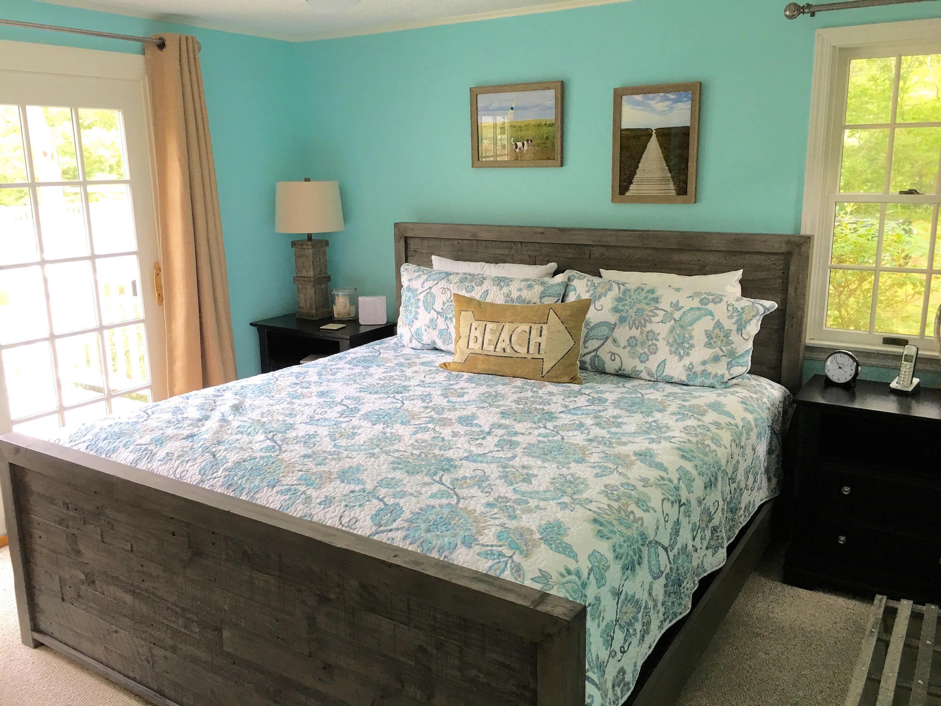 112 3rd Street North Edgartown, MA 02539 - Photo 9 of 15 a large bed sitting in a bedroom next to a window