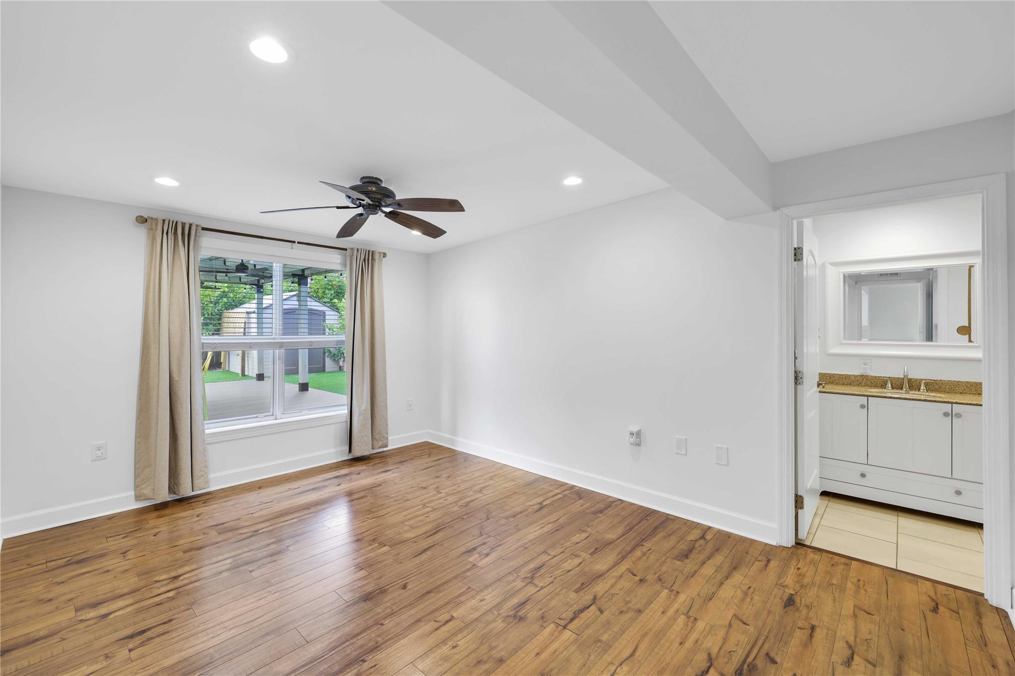 413 Philadelphia Drive Jupiter, FL 33458 - Photo 14 of 35 a view of an empty room with a window and wooden floor