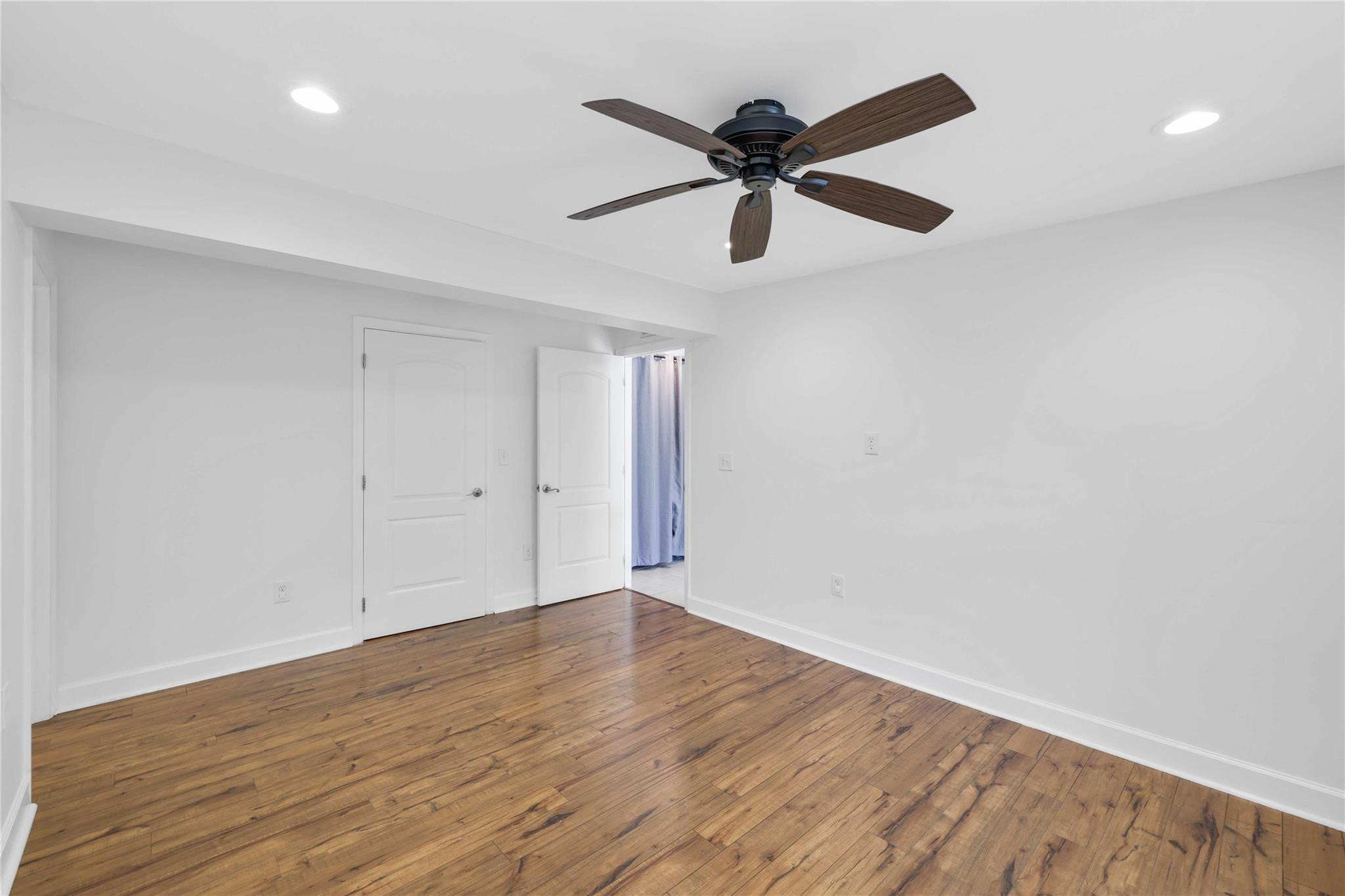 413 Philadelphia Drive Jupiter, FL 33458 - Photo 15 of 35 a view of a big room with wooden floor and a ceiling fan