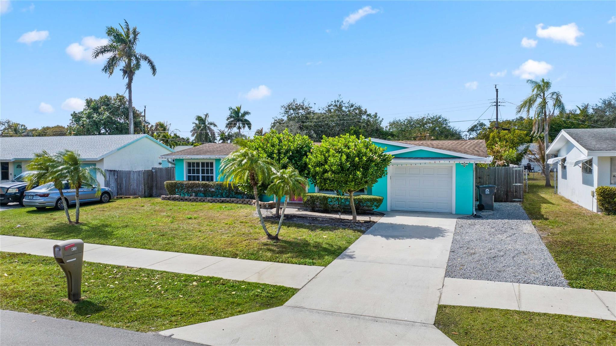 413 Philadelphia Drive Jupiter, FL 33458 - Photo 4 of 35 a front view of a house with a garden and yard