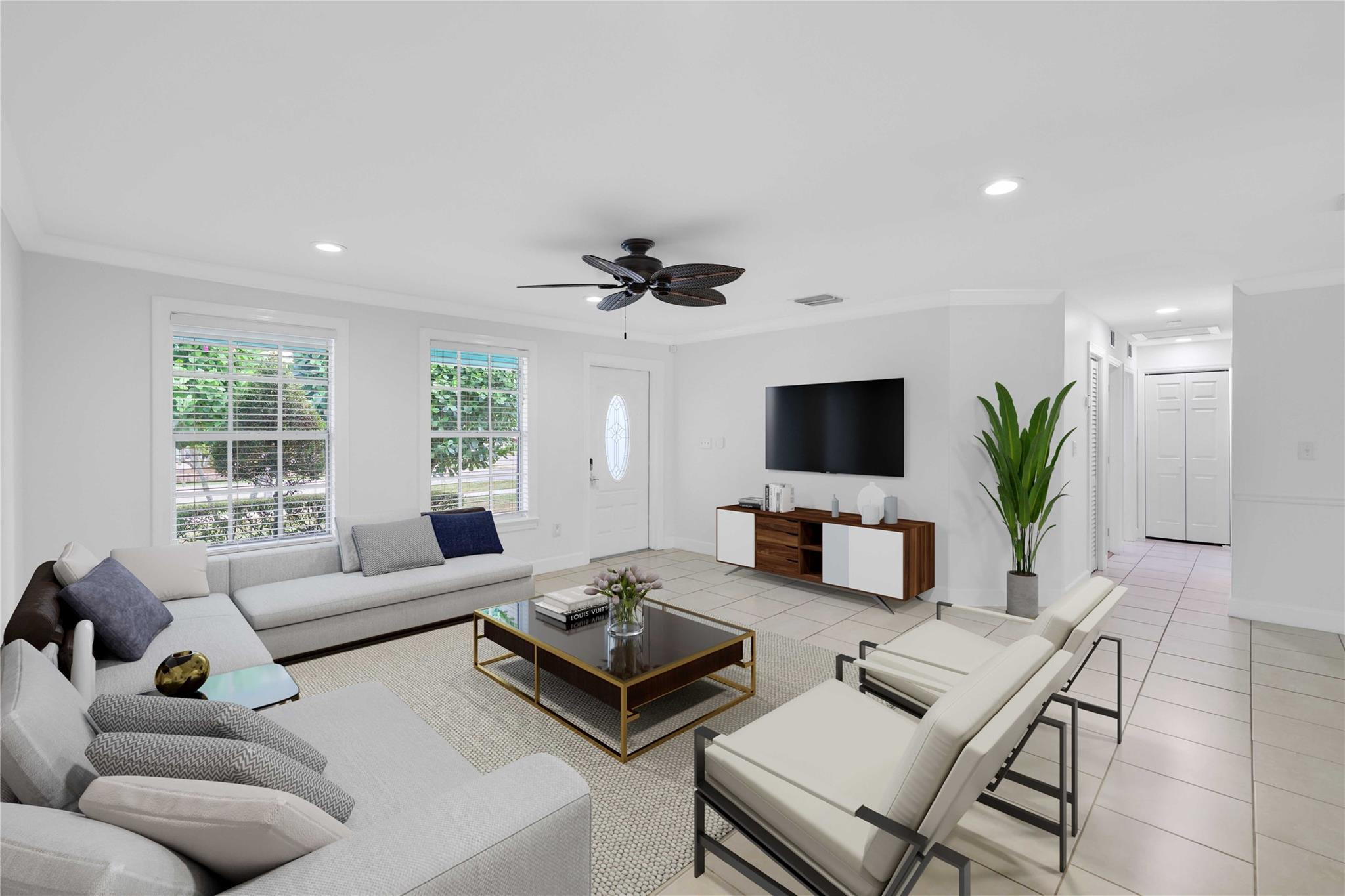 413 Philadelphia Drive Jupiter, FL 33458 - Photo 8 of 35 a living room with furniture a flat screen tv and a large window
