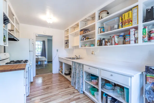a living room with lots of furniture and baby crib